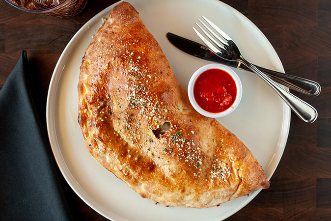 Order CYO Calzone food online from Rocco's Pizzeria store, San Antonio on bringmethat.com