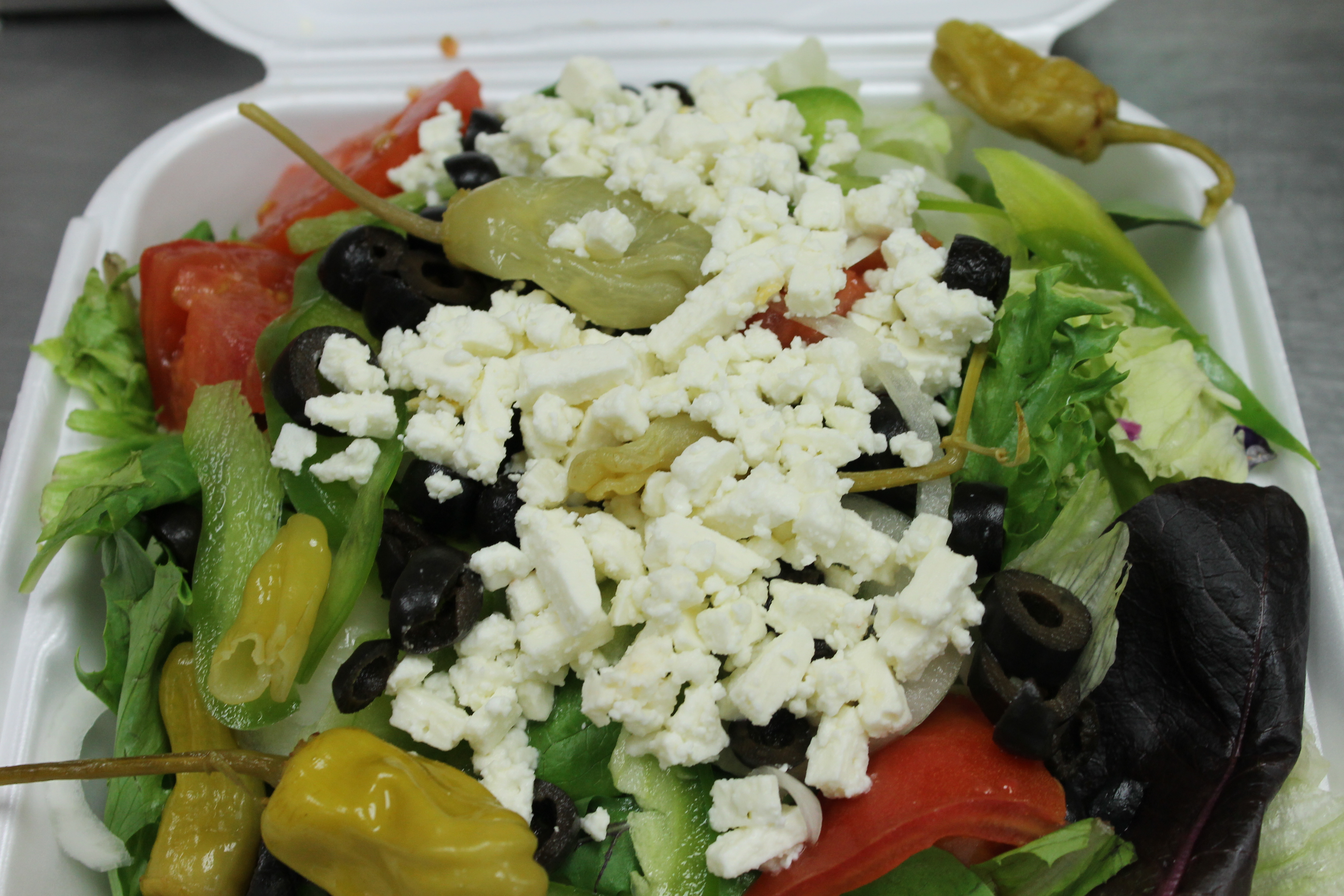Order Greek Salad food online from Bellacino's Pizza & Grinders store, Keego Harbor on bringmethat.com