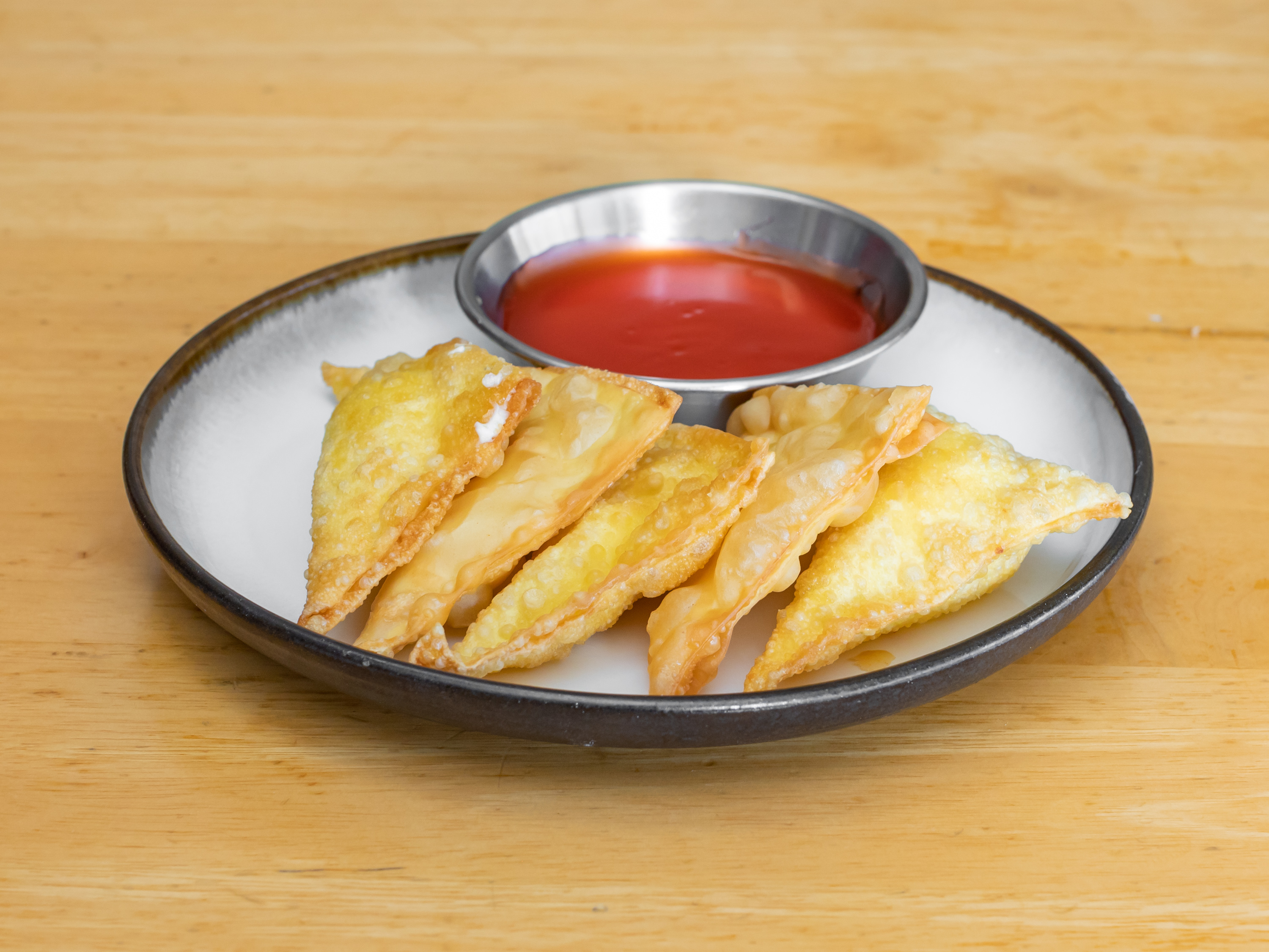 Order A7. Crab Rangoon food online from Rice King Chinese Restaurant store, Toledo on bringmethat.com