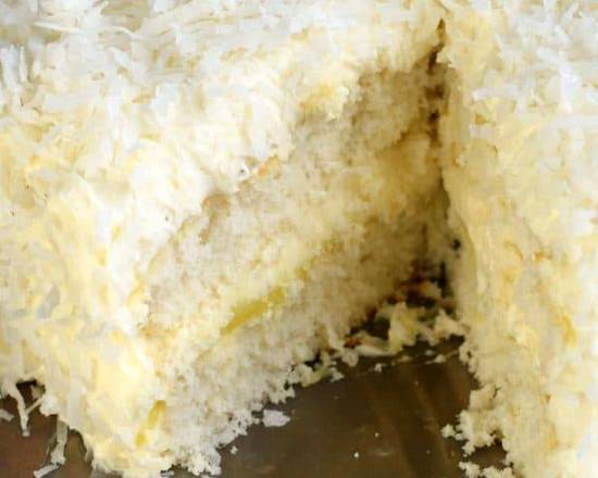 Order Fresh X-Large Coconut Lemon Cake Slice with Whip Cream food online from Ny Popcorn store, New York on bringmethat.com
