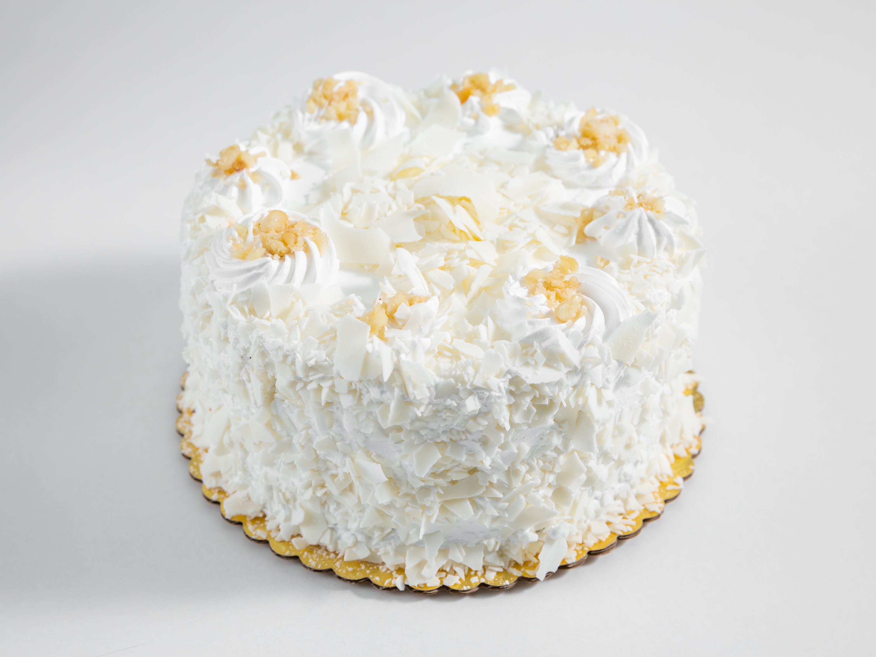 Order White Chocolate Macadamia Mousse Cake food online from It A Piece A Cake store, San Diego on bringmethat.com