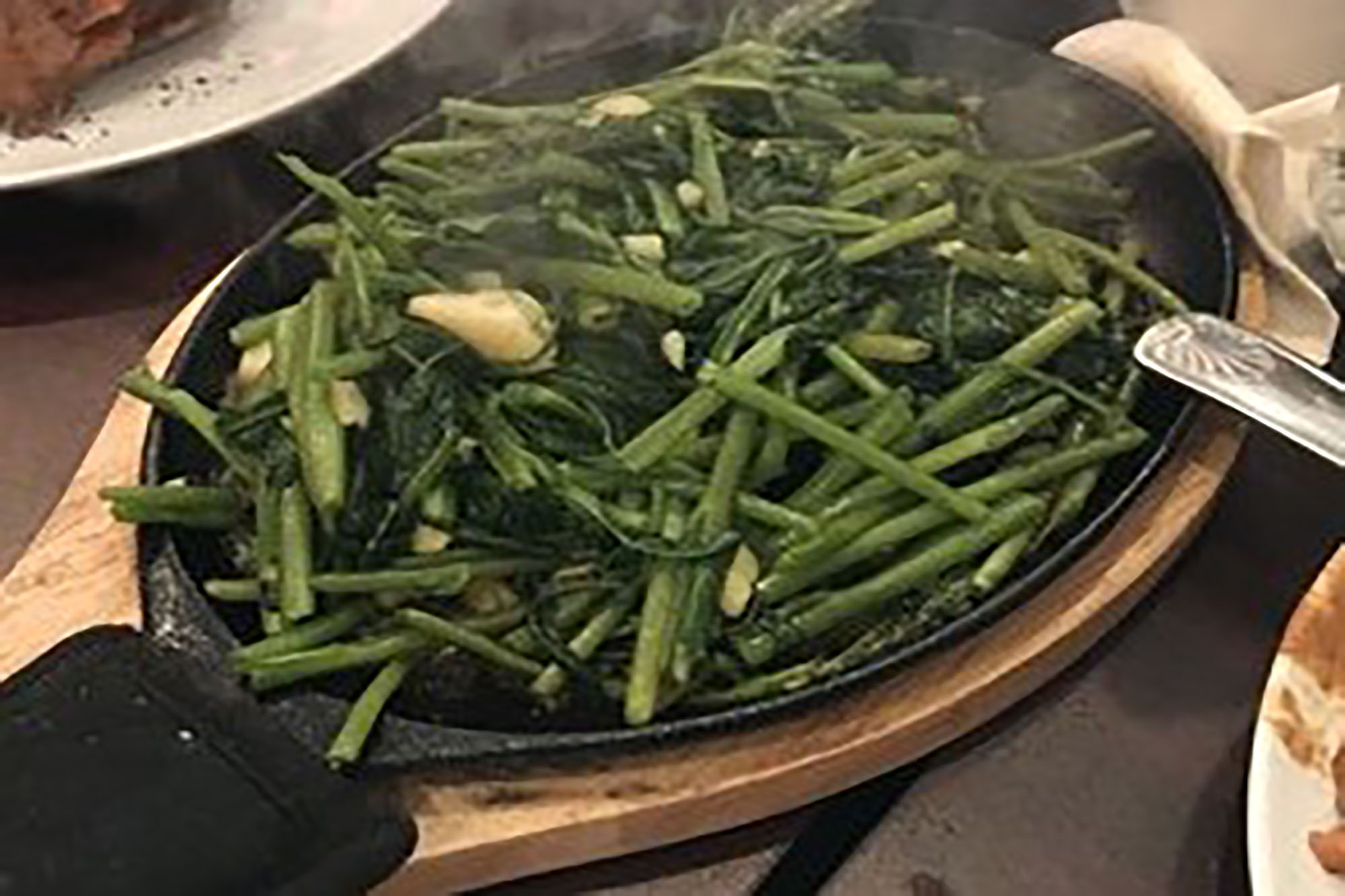 Order Tumis Kangkung Hot Plate / Water Spinach Sautee Hot Plate food online from Awang Kitchen store, Elmhurst on bringmethat.com