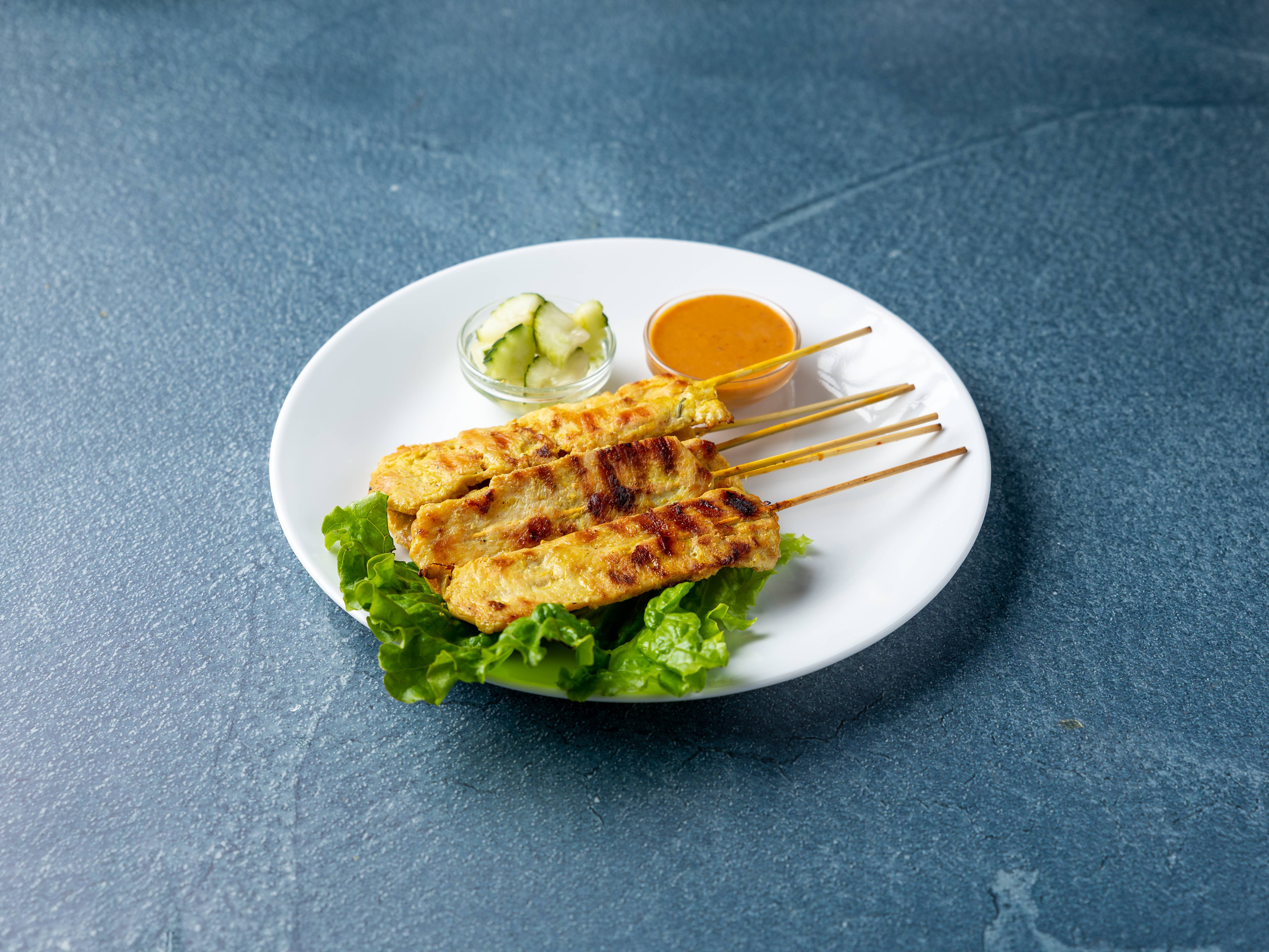 Order 4 Pieces Chicken Satay food online from Charm Thai Cuisine store, Oklahoma City on bringmethat.com