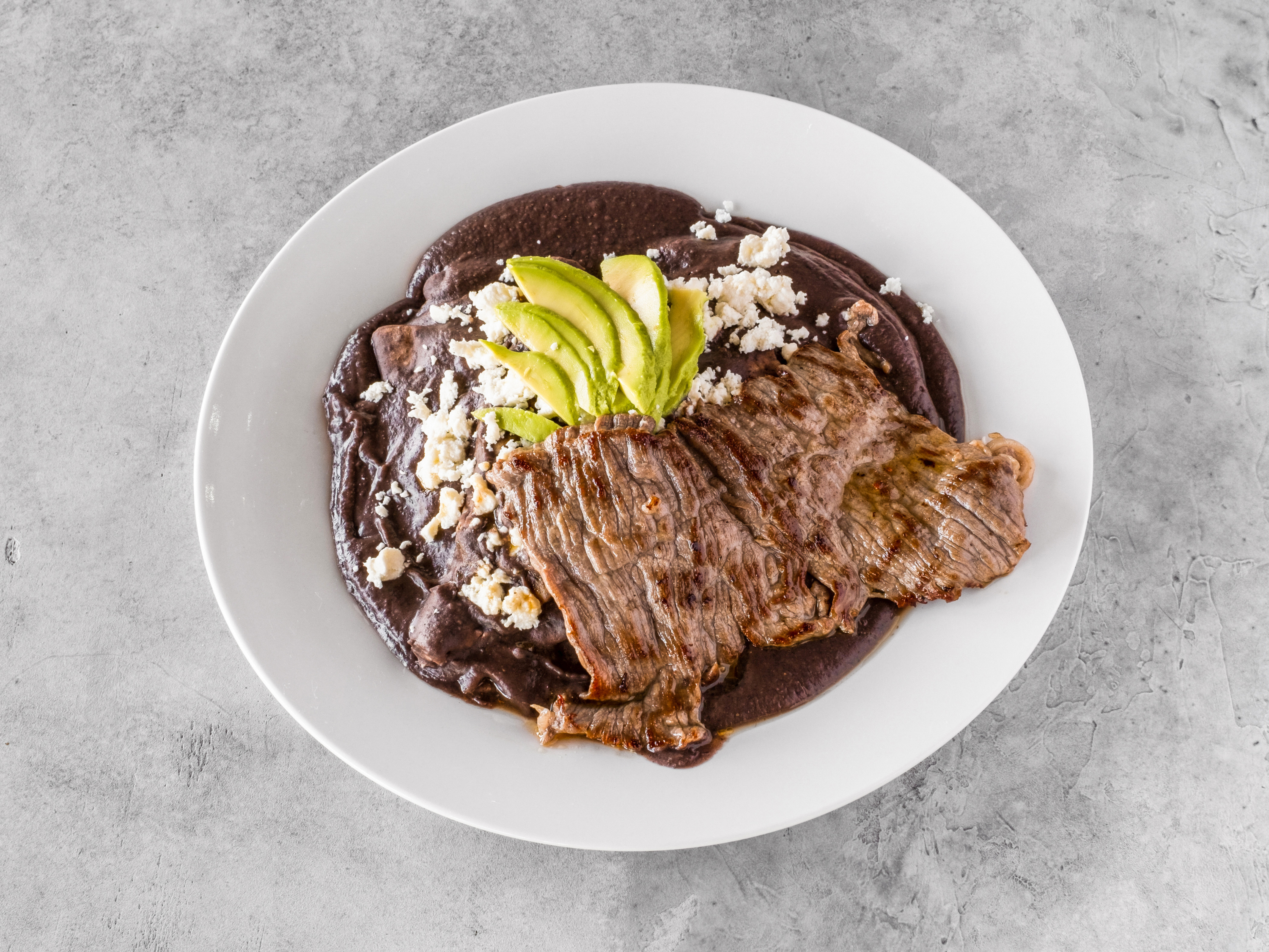 Order Enfrijoladas con Tasajo ( steak) food online from Francis Bakery And Mexican Food store, Thousand Oaks on bringmethat.com