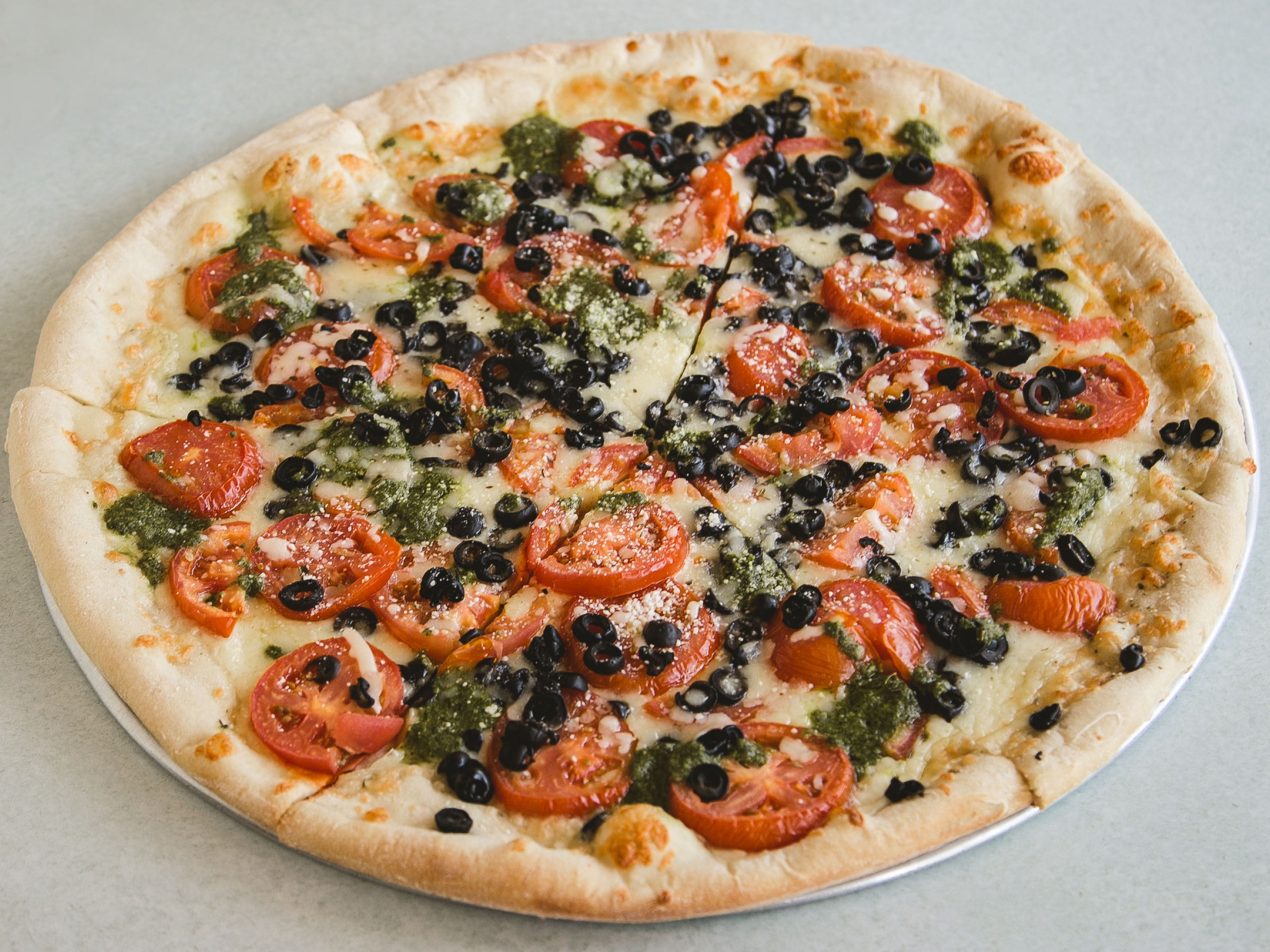 Order Fresh Tomato, Black Olives and Pesto Sauce Pizza food online from Renato Pizza store, Swarthmore on bringmethat.com