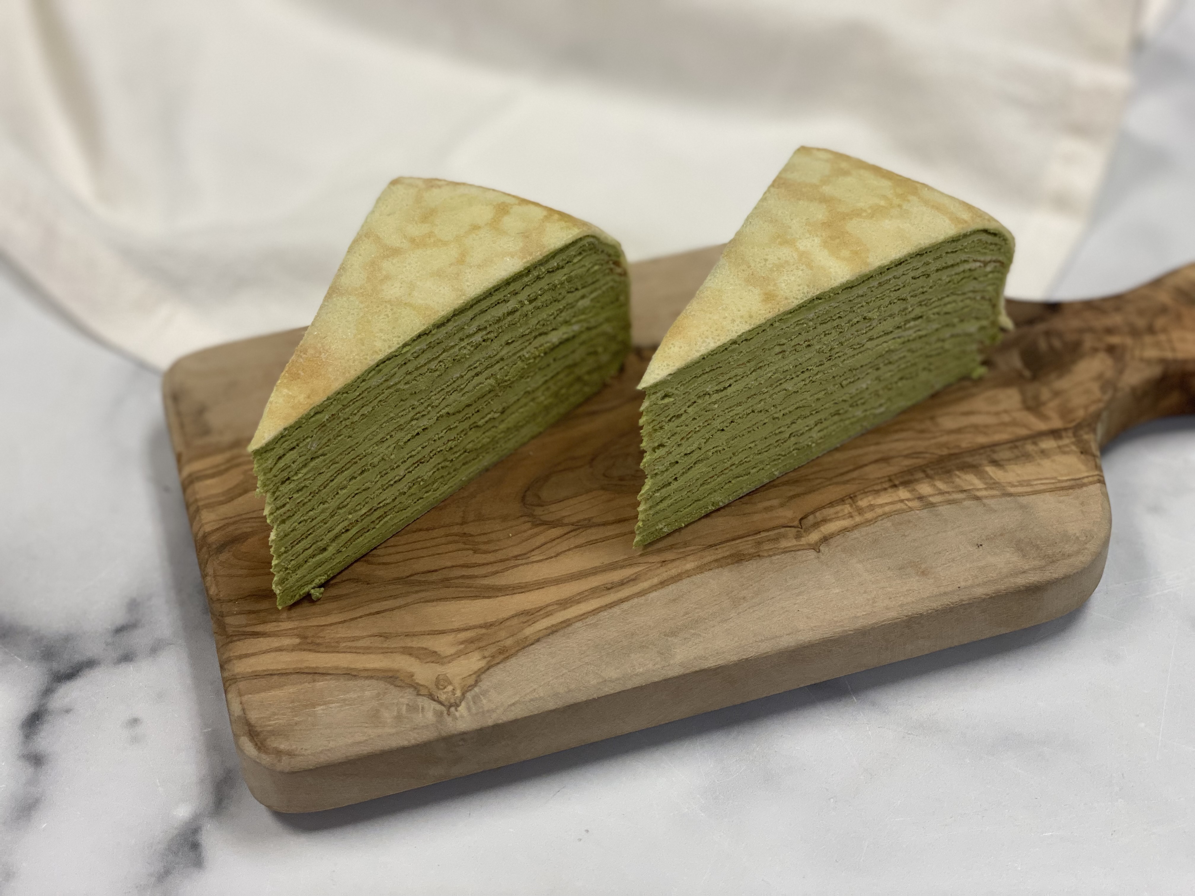 Order Set of 2 Matcha Mille Crepe Cake food online from 43 & Company store, Milpitas on bringmethat.com