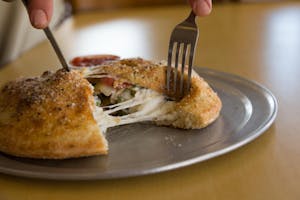 Order Ham Calzone food online from Massino's Pizzeria store, Aurora on bringmethat.com