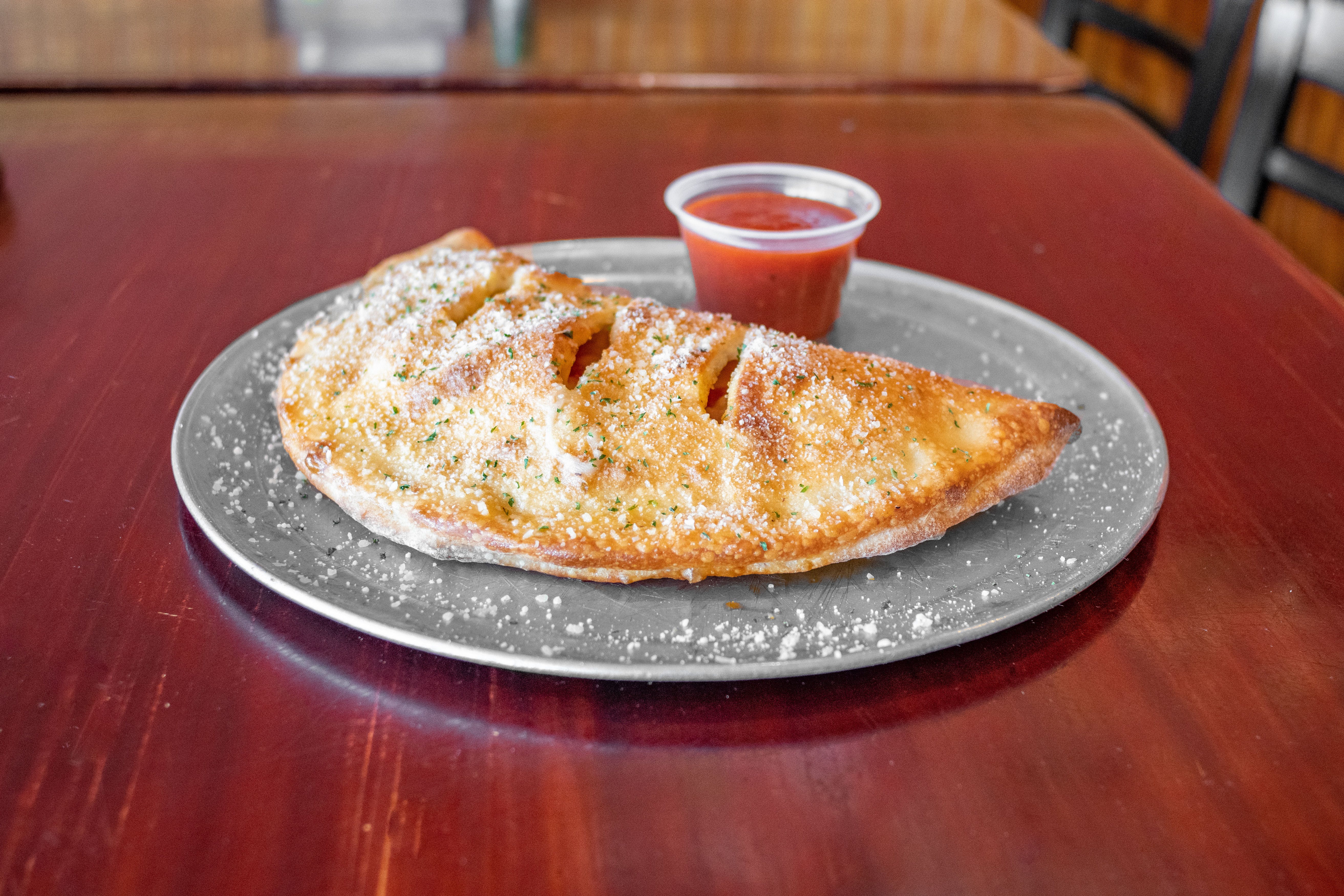 Order Calzone with One Topping - Small food online from Julia's Pizza store, Orlando on bringmethat.com