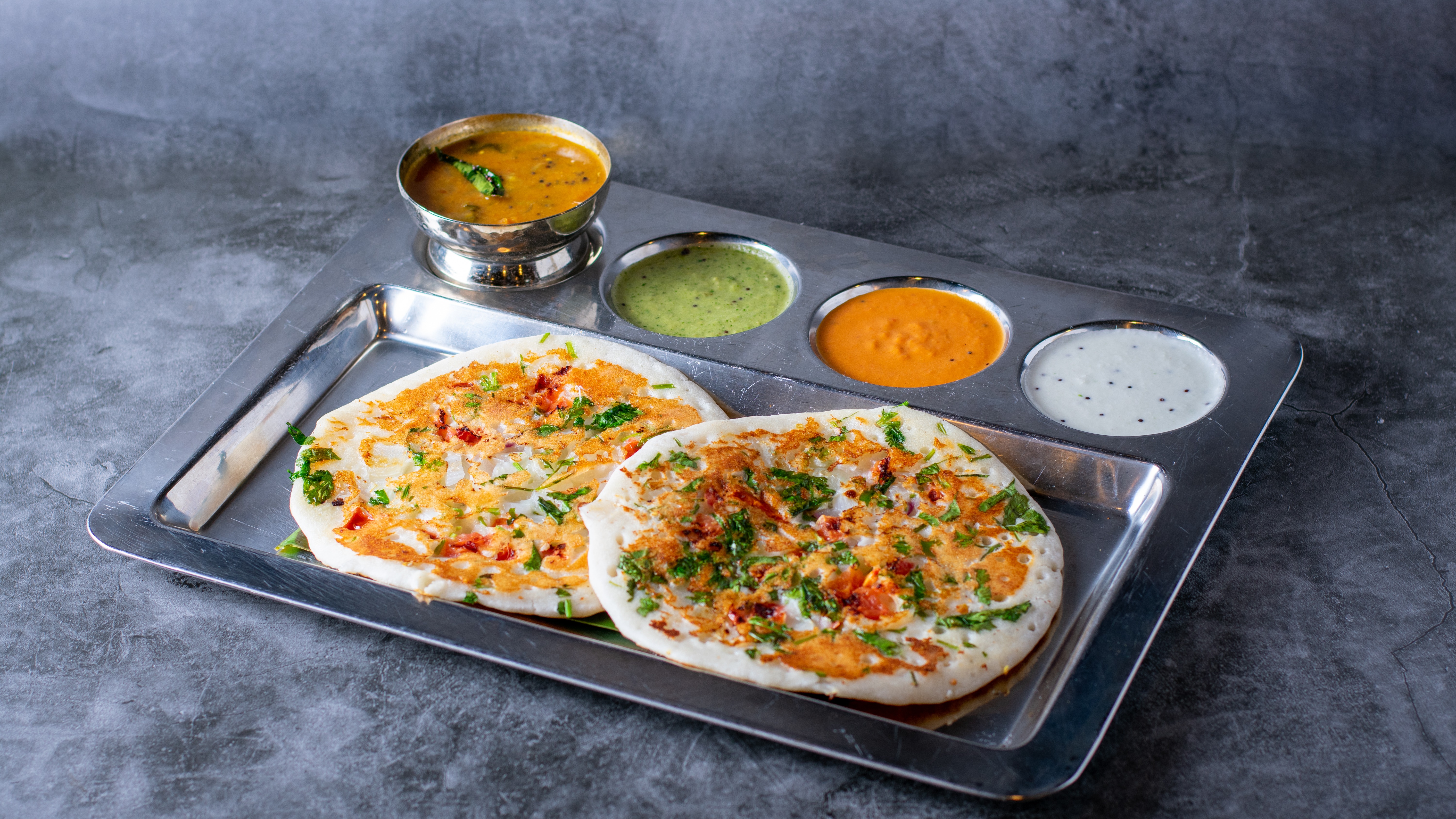 Order Veg Uthappam - 2 pieces food online from Sangam Chettinad Indian Cuisine store, Austin on bringmethat.com