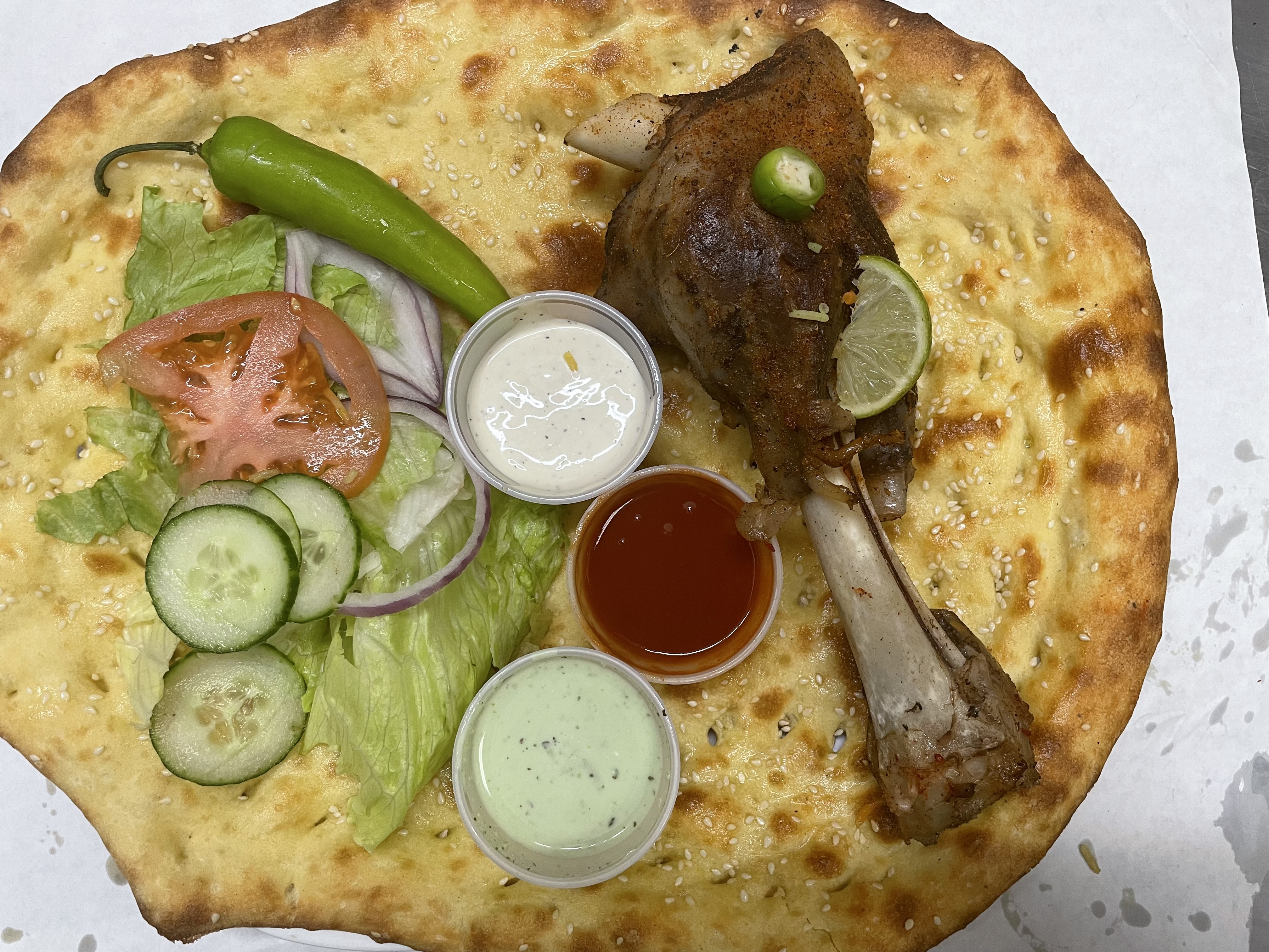 Order 33. lamb shank with naan food online from Peshawri Kebab store, Waltham on bringmethat.com