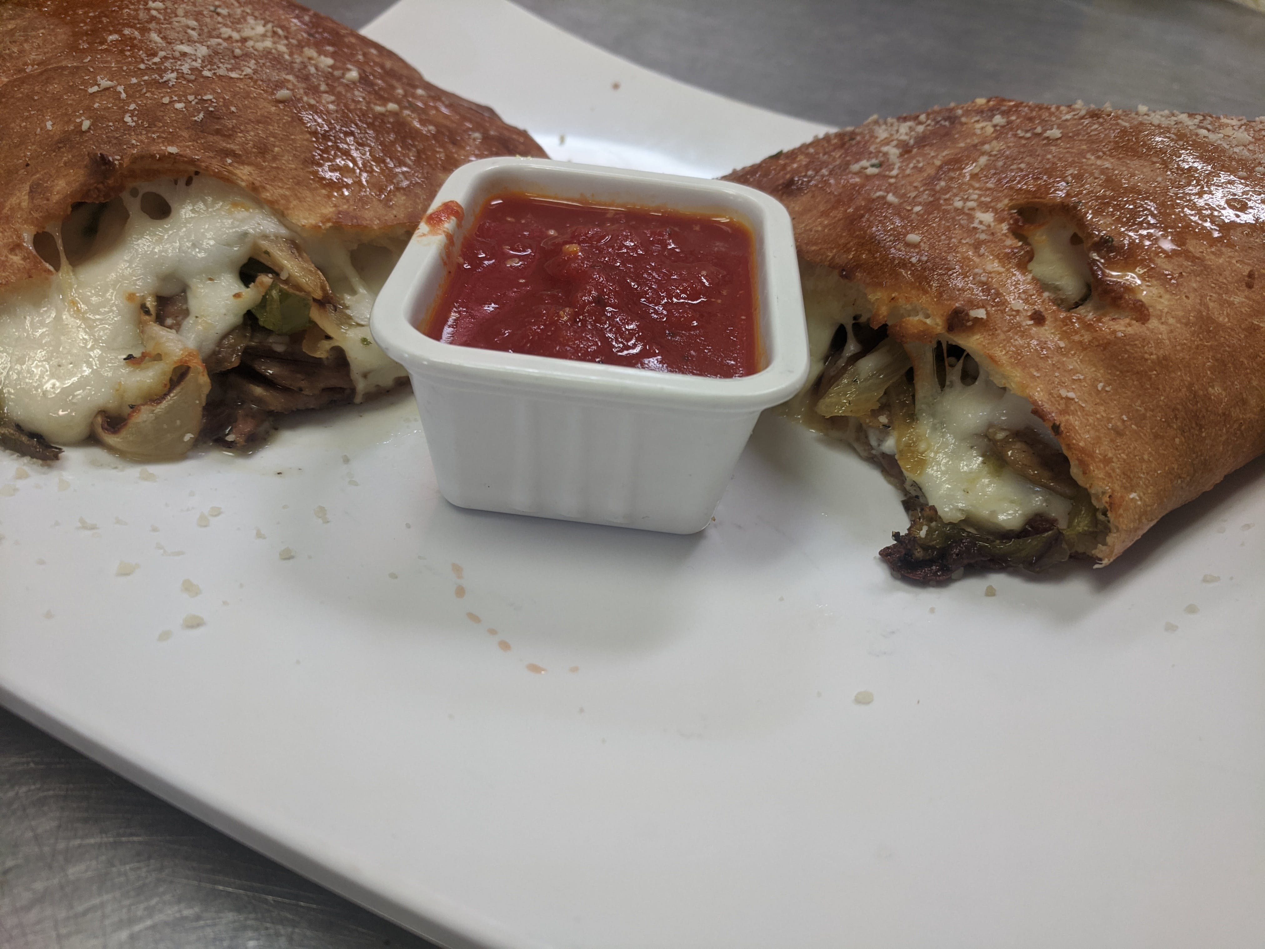 Order Sausage, Peppers & Onion Calzone - Calzone food online from Bella Pizza & Pasta store, Mesa on bringmethat.com