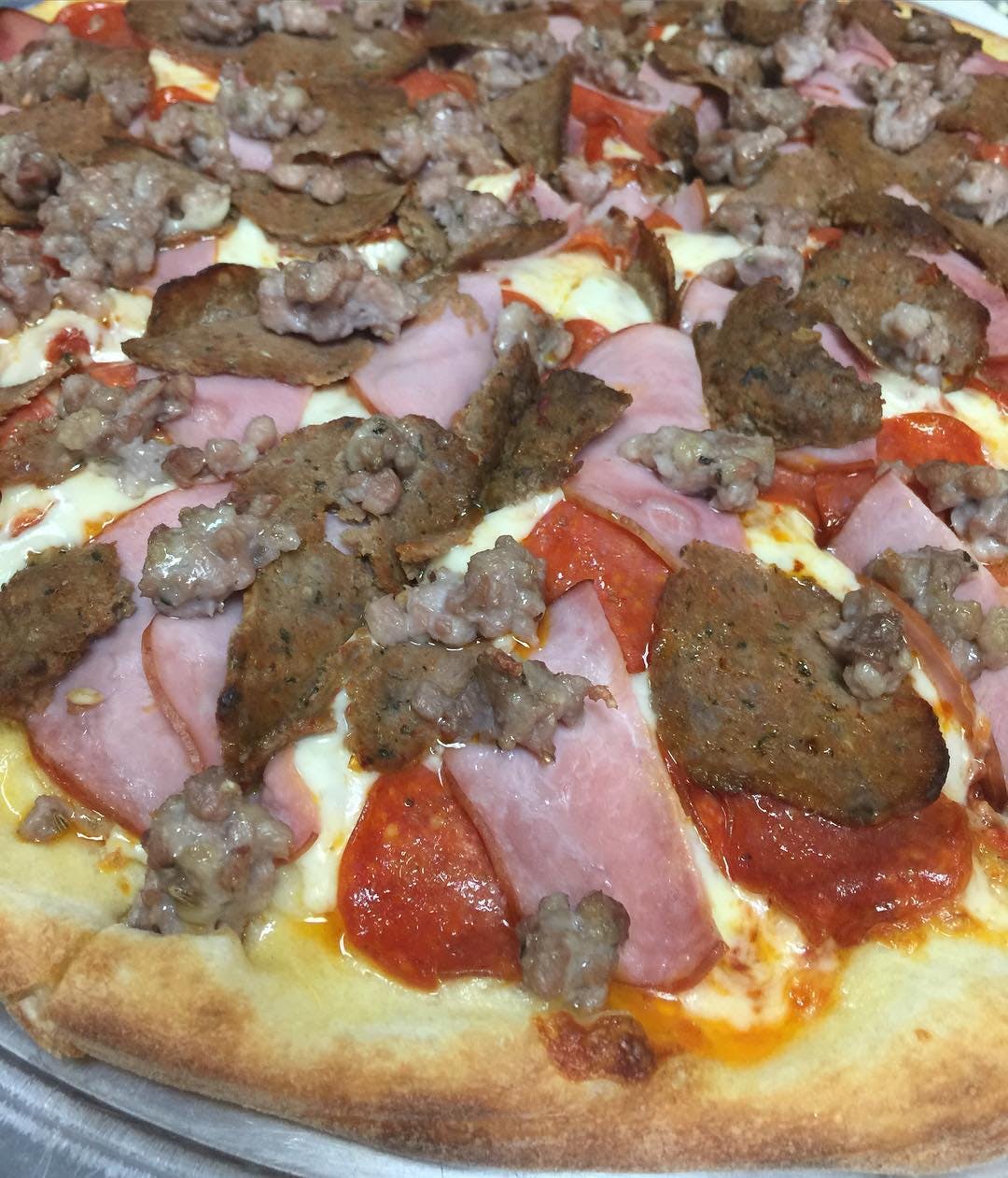Order Meat Lovers Pizza - Medium 14" (6 Slices) food online from Massimo Pizzeria store, Southampton on bringmethat.com