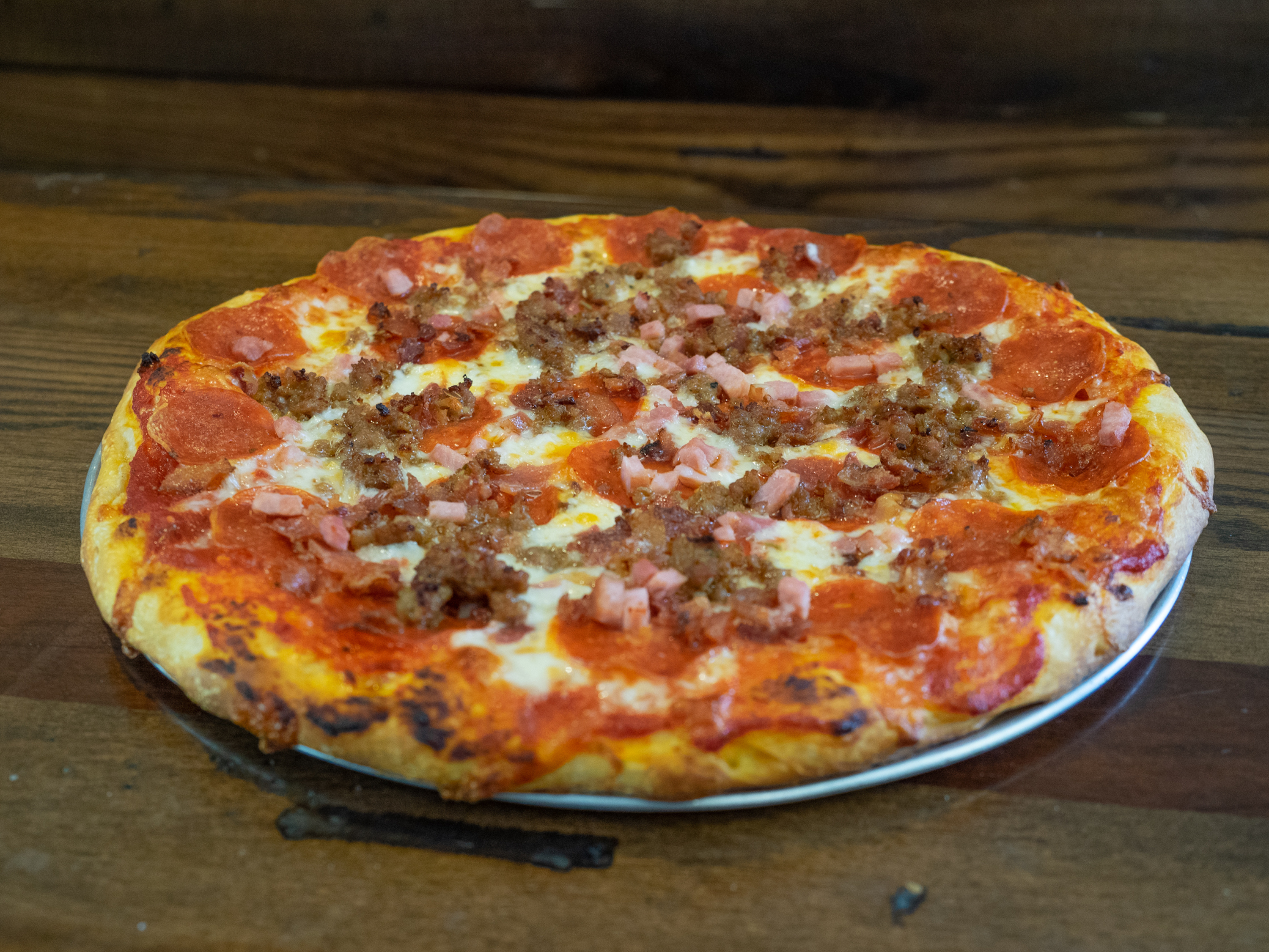 Order Meat Lovers Pizza food online from Uncle Scott's Pizza store, Hendersonville on bringmethat.com