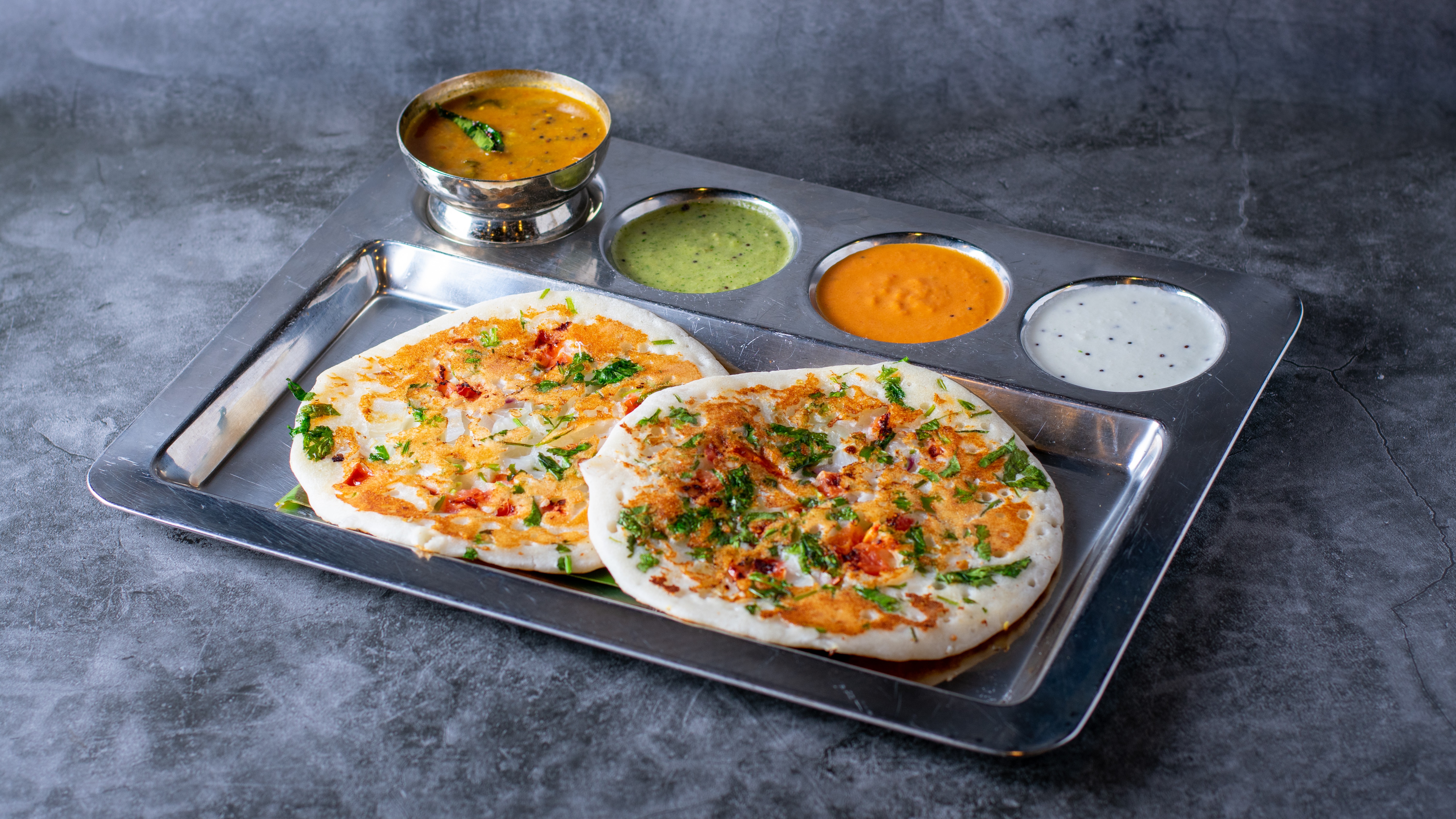 Order Onion Uthappam - 2 Pieces food online from Sangam Chettinad Indian Cuisine store, Austin on bringmethat.com
