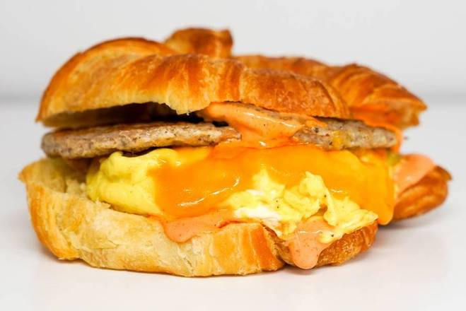 Order Croissant Sausage, Egg and Cheddar Sandwich food online from Sunday Best Breakfast Sandwiches store, View Park-Windsor Hills on bringmethat.com