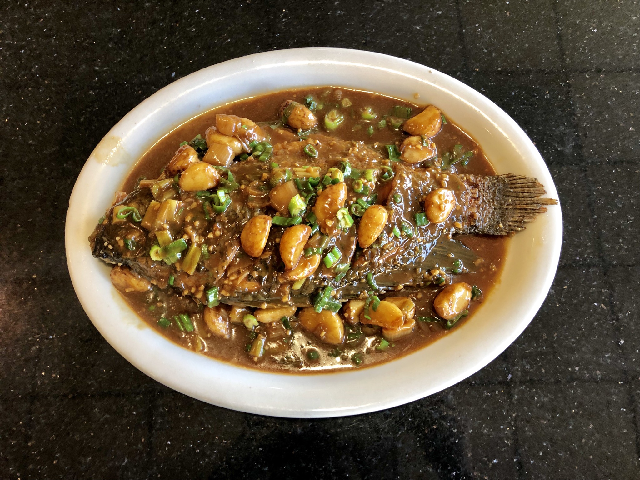 Order 124. Tilapia Fish with Garlic in Brown Sauce food online from Belly Bombz Kitchen store, Artesia on bringmethat.com