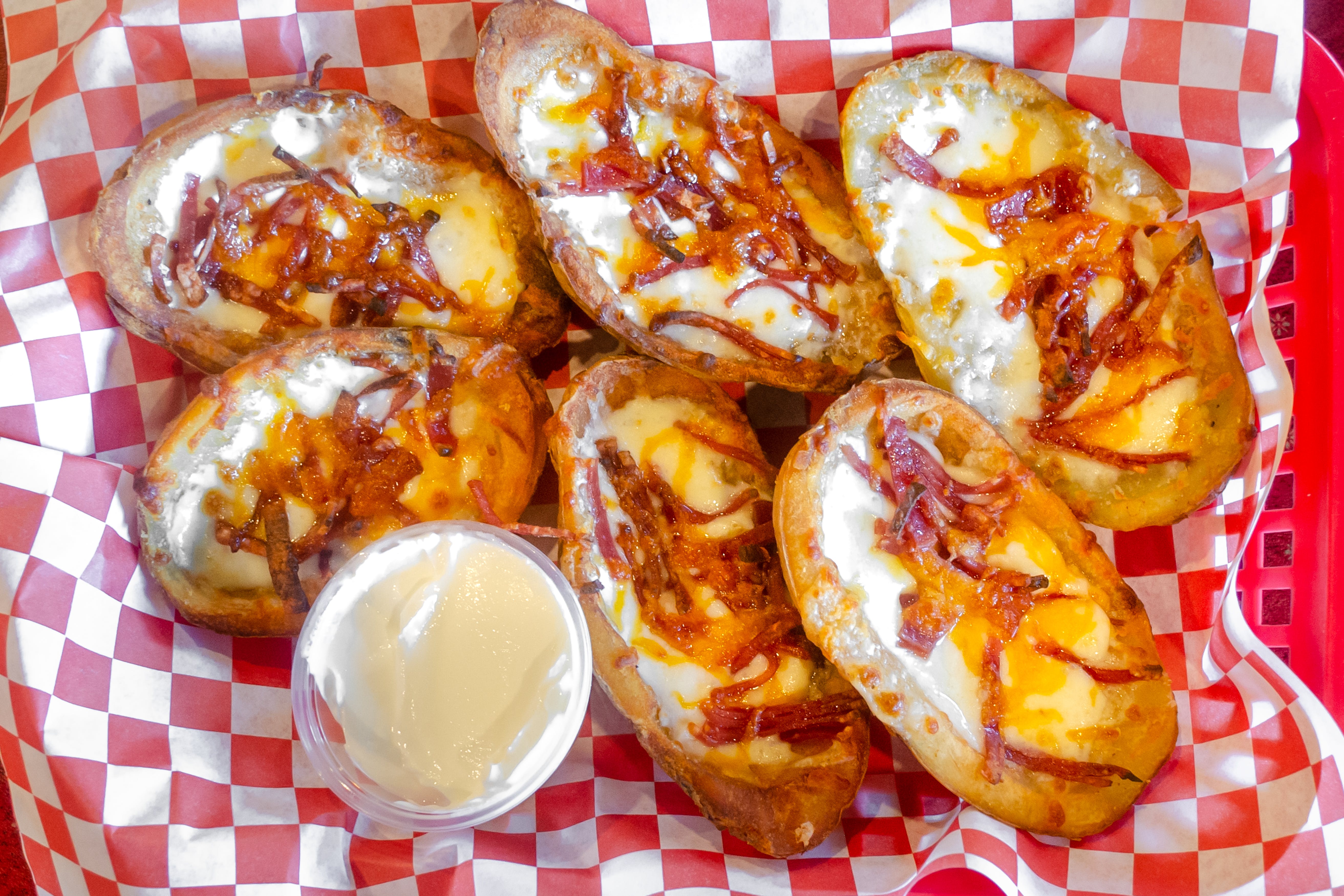 Order Loaded Potato Skins - 6 Pieces food online from E Milano Pizza store, Nashville on bringmethat.com