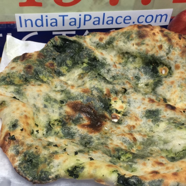 Order C11. Spinach Naan food online from India Taj Palace store, San Antonio on bringmethat.com