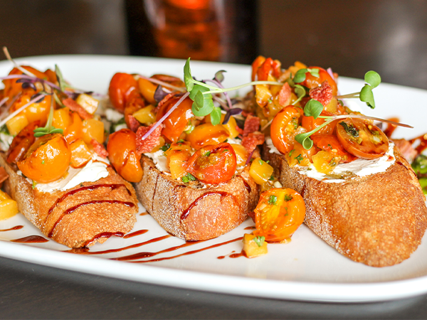 Order Peach-Tomato Bruschetta food online from Firerock Grille store, Caledonia on bringmethat.com