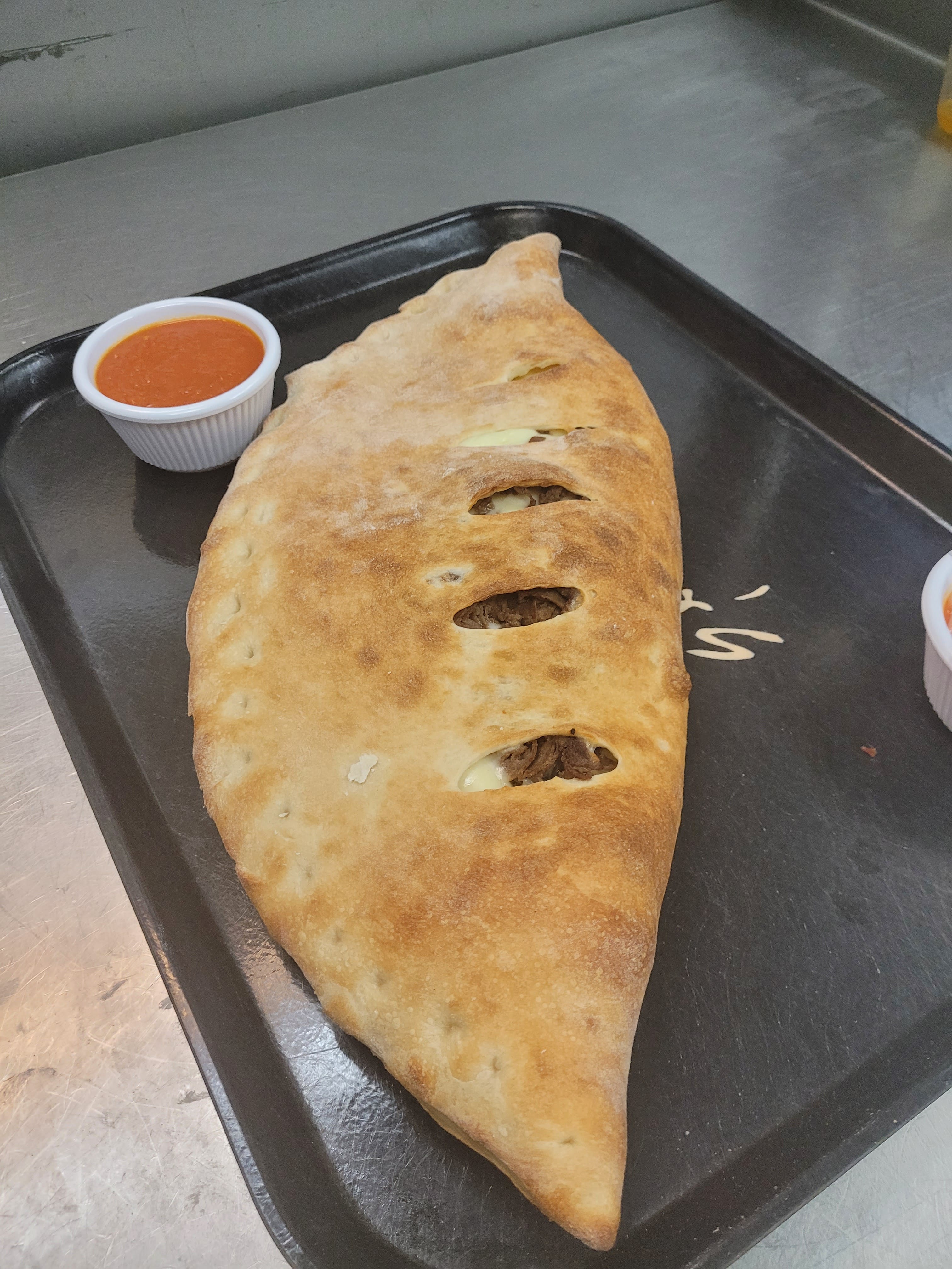 Order Meat Lovers Calzone - Medium food online from Brother's Pizza Chambersburg store, Chambersburg on bringmethat.com