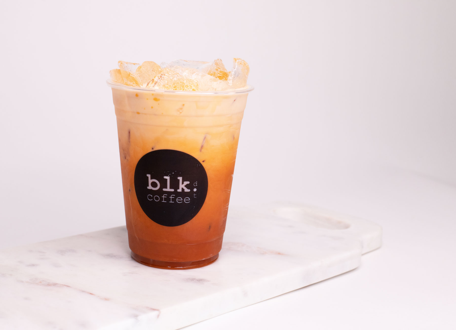 Order Iced Thai Tea food online from Blk Dot Coffee store, Irvine on bringmethat.com