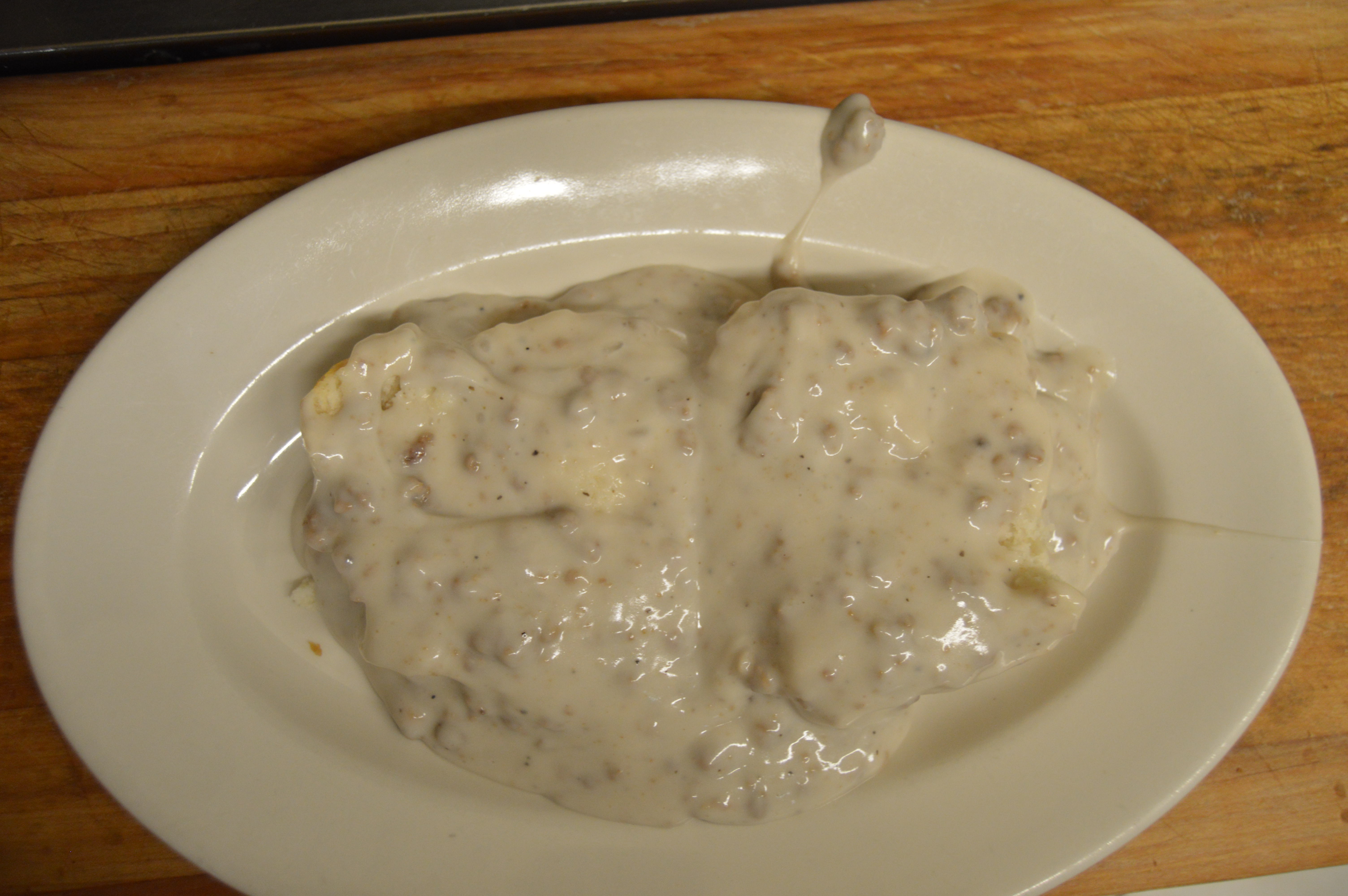Order Homemade Sausage Gravy with Biscuit food online from Angelas family restaurant store, Cleveland on bringmethat.com